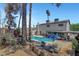 An in-ground pool in a backyard, with patio furniture and mature trees and shrubs visible at 5019 Lancaster Dr, Las Vegas, NV 89120