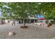 Spacious backyard showcasing a gravel landscape with stone pavers, a hot tub, and an outdoor barbecue area at 5200 Wheatland Dr, Pahrump, NV 89061
