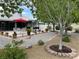 Gorgeous backyard featuring gravel, mature trees, landscaping, dining area, and outdoor kitchen at 5200 Wheatland Dr, Pahrump, NV 89061