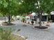 Backyard featuring lush trees, a built-in grill, and gravel landscape at 5200 Wheatland Dr, Pahrump, NV 89061