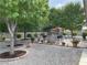 Backyard featuring lush trees, a built-in grill, and an outdoor dining area at 5200 Wheatland Dr, Pahrump, NV 89061