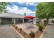 Well-manicured backyard featuring stone pavers, gravel landscaping, outdoor dining area and barbeque at 5200 Wheatland Dr, Pahrump, NV 89061