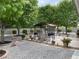 Backyard featuring lush trees, a built-in grill, and gravel landscape at 5200 Wheatland Dr, Pahrump, NV 89061