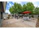 Backyard with a patio, complete with a grill, outdoor seating, and mature landscaping at 5200 Wheatland Dr, Pahrump, NV 89061