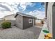 Backyard featuring a storage shed, landscaping, and a concrete walkway, offering utility and charm at 5200 Wheatland Dr, Pahrump, NV 89061