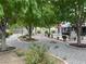 Serene backyard showcasing mature landscaping, including trees, gravel, and meticulously designed plant beds at 5200 Wheatland Dr, Pahrump, NV 89061