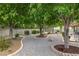 Landscaped backyard featuring mature trees and decorative gravel ground cover, providing a serene outdoor space at 5200 Wheatland Dr, Pahrump, NV 89061