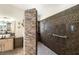Stylish bathroom featuring a glass shower, stone accent wall, and a built-in bench at 5200 Wheatland Dr, Pahrump, NV 89061