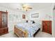 Cozy bedroom features a ceiling fan, natural light from a window, and classic wood furnishings at 5200 Wheatland Dr, Pahrump, NV 89061
