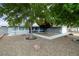 Home featuring a xeriscaped front yard with mature trees and a welcoming walkway to the entrance at 5200 Wheatland Dr, Pahrump, NV 89061