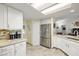 Bright kitchen featuring a stainless steel refrigerator, tiled backsplash, granite counters, and coffee maker at 5200 Wheatland Dr, Pahrump, NV 89061