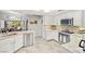 Bright kitchen featuring stainless steel appliances, granite counters, white cabinets, and a tile backsplash at 5200 Wheatland Dr, Pahrump, NV 89061