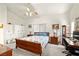 Bright main bedroom featuring natural light, ceiling fan, a work desk, and closet space at 5200 Wheatland Dr, Pahrump, NV 89061