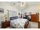 Spacious main bedroom with a ceiling fan, natural light, and a work desk area at 5200 Wheatland Dr, Pahrump, NV 89061