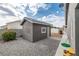 Exterior shot of backyard shed, painted grey and equipped with a satellite dish at 5200 Wheatland Dr, Pahrump, NV 89061