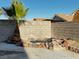 Backyard view with rock garden, privacy wall, mature palm tree, and partial privacy wall at 529 Rancho Del Mar Way, North Las Vegas, NV 89031