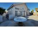 Spacious backyard with stucco walls, concrete patio and a decorative bird bath on pedestal at 529 Rancho Del Mar Way, North Las Vegas, NV 89031