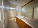 Bathroom featuring tub, toilet, and sink with large mirror at 529 Rancho Del Mar Way, North Las Vegas, NV 89031