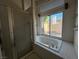Bathroom including tub, shower with glass door, and large window at 529 Rancho Del Mar Way, North Las Vegas, NV 89031