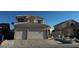 Two-story home showcasing a well-manicured lawn, classic stucco, and a spacious two-car garage at 529 Rancho Del Mar Way, North Las Vegas, NV 89031