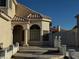 Welcoming front entryway with elegant stucco columns, arched window and decorative iron gate on side at 529 Rancho Del Mar Way, North Las Vegas, NV 89031