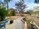 Relaxing backyard oasis with a patio, custom fire pit, manicured landscaping, and decorative rock at 5381 Waving Sage Dr, Las Vegas, NV 89149