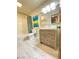 This bathroom features a rustic vanity, a full bathtub with shower and a modern toilet at 5381 Waving Sage Dr, Las Vegas, NV 89149