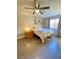 Cozy bedroom with natural light, wood-look tile floors, and ceiling fan at 5381 Waving Sage Dr, Las Vegas, NV 89149