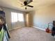 Neutral bedroom with a ceiling fan, carpet flooring and light colored walls at 5381 Waving Sage Dr, Las Vegas, NV 89149