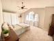 Cozy bedroom featuring a ceiling fan, carpet flooring and a bright window at 5381 Waving Sage Dr, Las Vegas, NV 89149