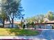 Luxury home with mature trees, a circular driveway, and a tile roof at 5381 Waving Sage Dr, Las Vegas, NV 89149