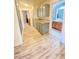 Long hallway with wood floors, built-in cabinets and access to the bathroom at 5381 Waving Sage Dr, Las Vegas, NV 89149