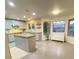 Bright kitchen with blue cabinets, an island, and seating area, enhanced by large windows at 5381 Waving Sage Dr, Las Vegas, NV 89149