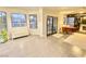 Spacious living area featuring tile flooring, large windows, and double French doors to the backyard at 5381 Waving Sage Dr, Las Vegas, NV 89149