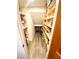 Walk-in pantry with wood shelving and grey wood-look flooring at 5381 Waving Sage Dr, Las Vegas, NV 89149