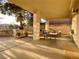 Covered patio with outdoor seating, a built-in BBQ, and views of the beautifully landscaped backyard at 5381 Waving Sage Dr, Las Vegas, NV 89149