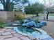 Scenic pond with stone accents and lush vegetation, creating a serene backyard retreat at 5381 Waving Sage Dr, Las Vegas, NV 89149