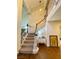 Elegant staircase with carpeted steps, white banisters, and hardwood floors at 5381 Waving Sage Dr, Las Vegas, NV 89149
