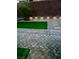 Backyard featuring artificial turf, a stone paver patio, and attractive lighting, perfect for entertaining and relaxation at 5627 Spanish Valor Rd, Las Vegas, NV 89135