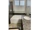 Bathroom featuring a soaking tub, marble countertop, a modern faucet, and window shutters at 5627 Spanish Valor Rd, Las Vegas, NV 89135