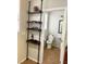 Bathroom with a toilet and sink, viewable from a doorway beside a wooden shelf at 5627 Spanish Valor Rd, Las Vegas, NV 89135