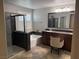 Elegant bathroom with a soaking tub, marble countertops, dual sinks, and a glass-enclosed shower at 5627 Spanish Valor Rd, Las Vegas, NV 89135
