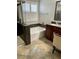 Bright bathroom with a soaking tub, marble countertops, dual sinks, and a glass-enclosed shower at 5627 Spanish Valor Rd, Las Vegas, NV 89135