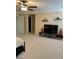 A generously sized bedroom offers an entertainment center and shelves creating a welcoming and stylish space at 5627 Spanish Valor Rd, Las Vegas, NV 89135