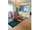 Dining room with chandelier lighting, colorful chairs, and modern rug at 5627 Spanish Valor Rd, Las Vegas, NV 89135