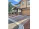 Two-story home with a paved driveway, two-car garage, and manicured landscaping at 5627 Spanish Valor Rd, Las Vegas, NV 89135