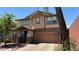 Inviting two-story home with a two-car garage, landscaped yard, and paved driveway at 5627 Spanish Valor Rd, Las Vegas, NV 89135