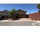 Lovely two-story home with a two-car garage, lush landscaping, and brick-paved driveway at 5627 Spanish Valor Rd, Las Vegas, NV 89135