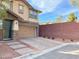 View of a home with a paved driveway and stone accents on the siding at 5627 Spanish Valor Rd, Las Vegas, NV 89135