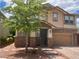 Charming two-story home boasts a beautifully designed exterior and a well-maintained front yard at 5627 Spanish Valor Rd, Las Vegas, NV 89135